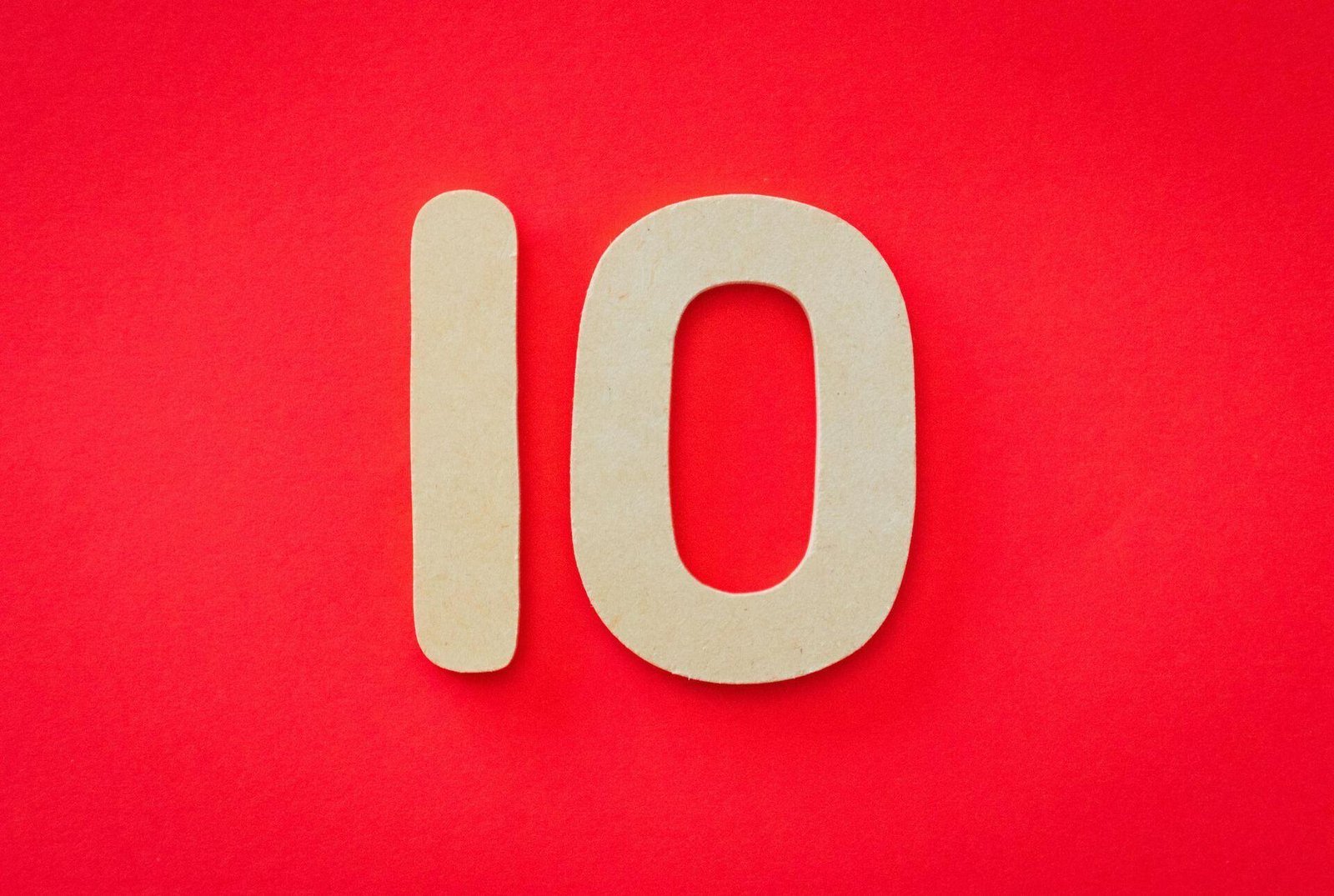 The number 10 in pale lettering against a red background.
