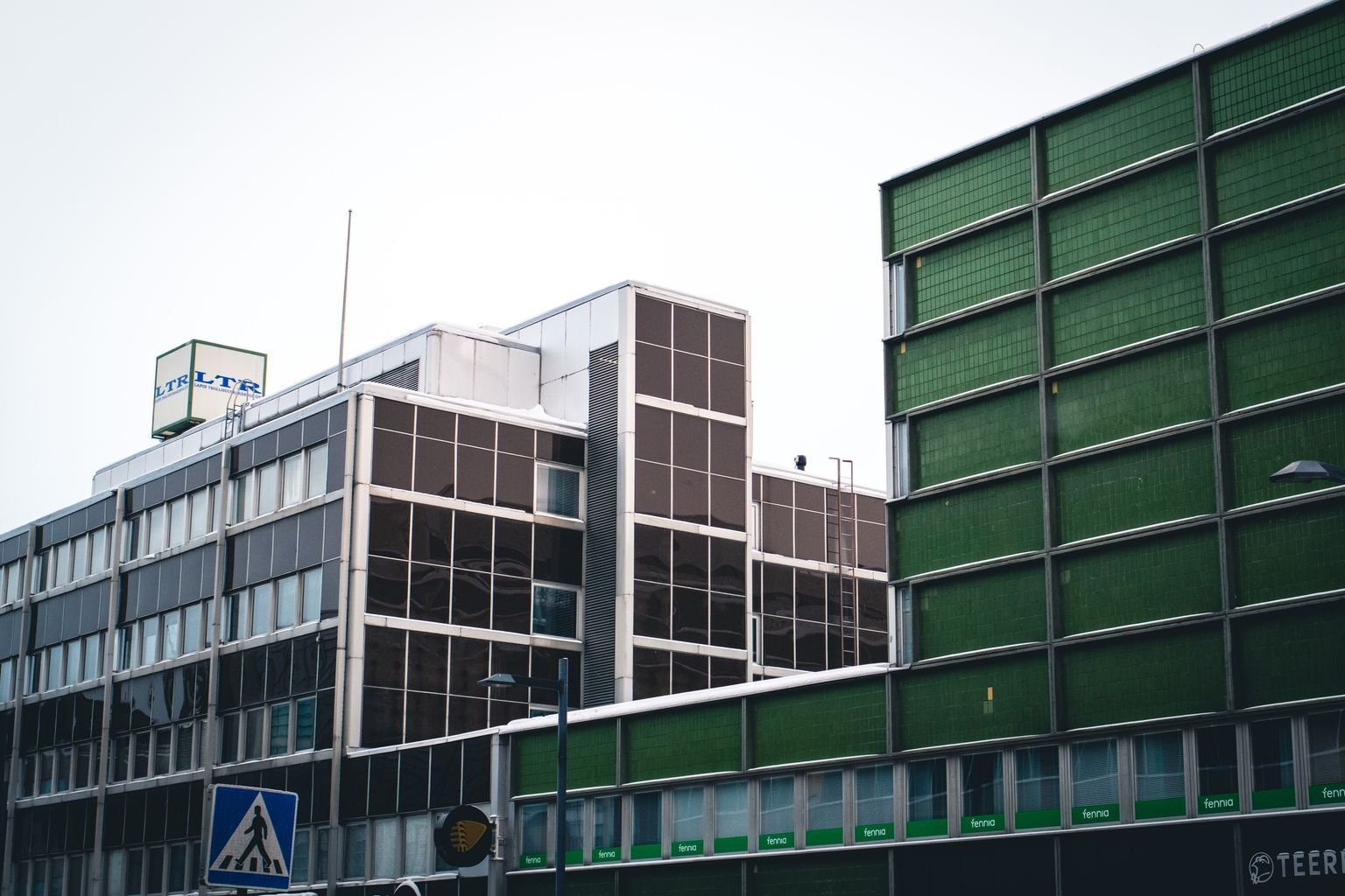 Modern commercial buildings viewed from street level.