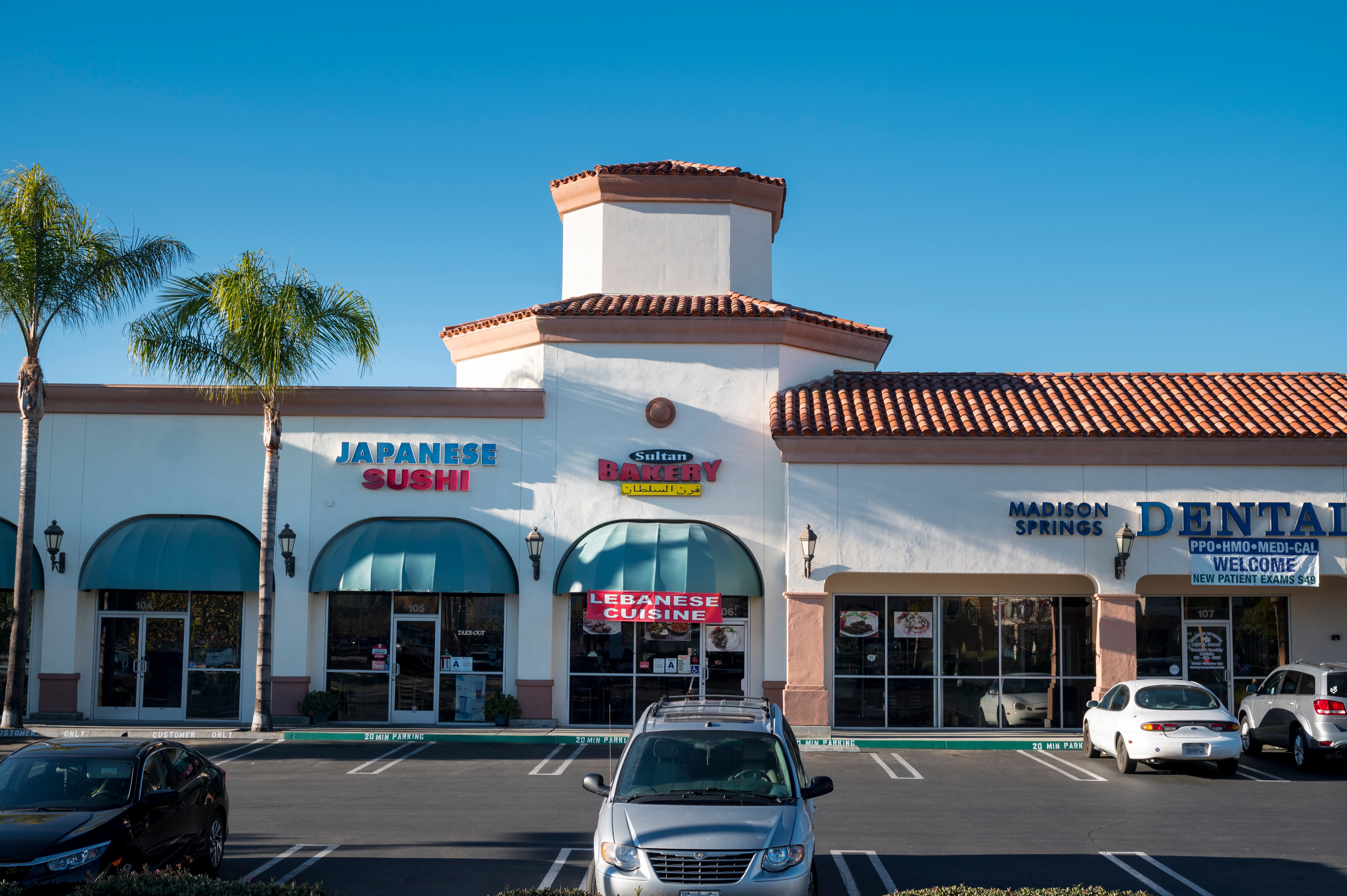 Parking spaces and tenant storefronts at Madison Springs Retail Center.