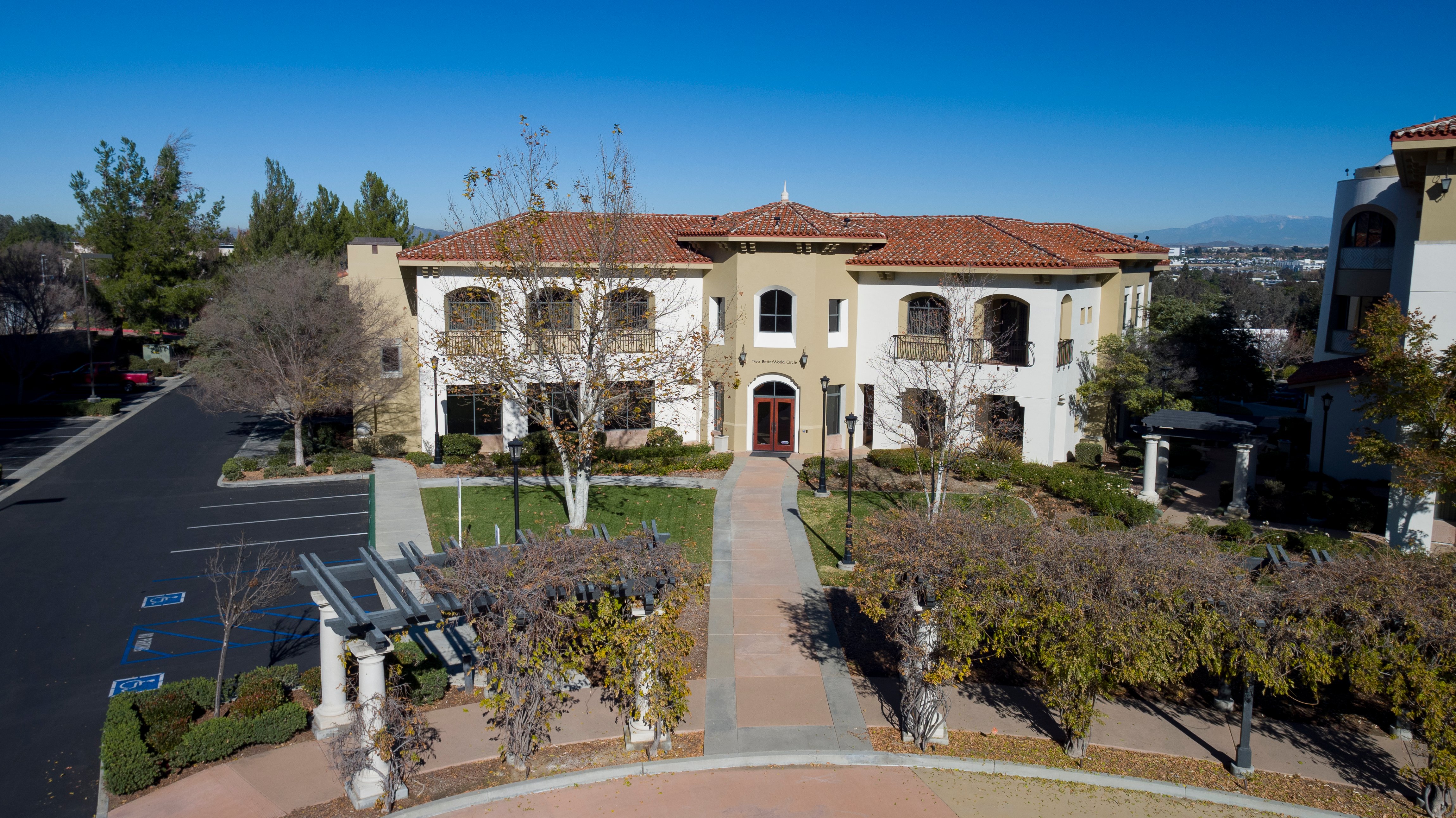 Aerial view of a Garrett Corporate Center office building, parking, and landscaped walkway.