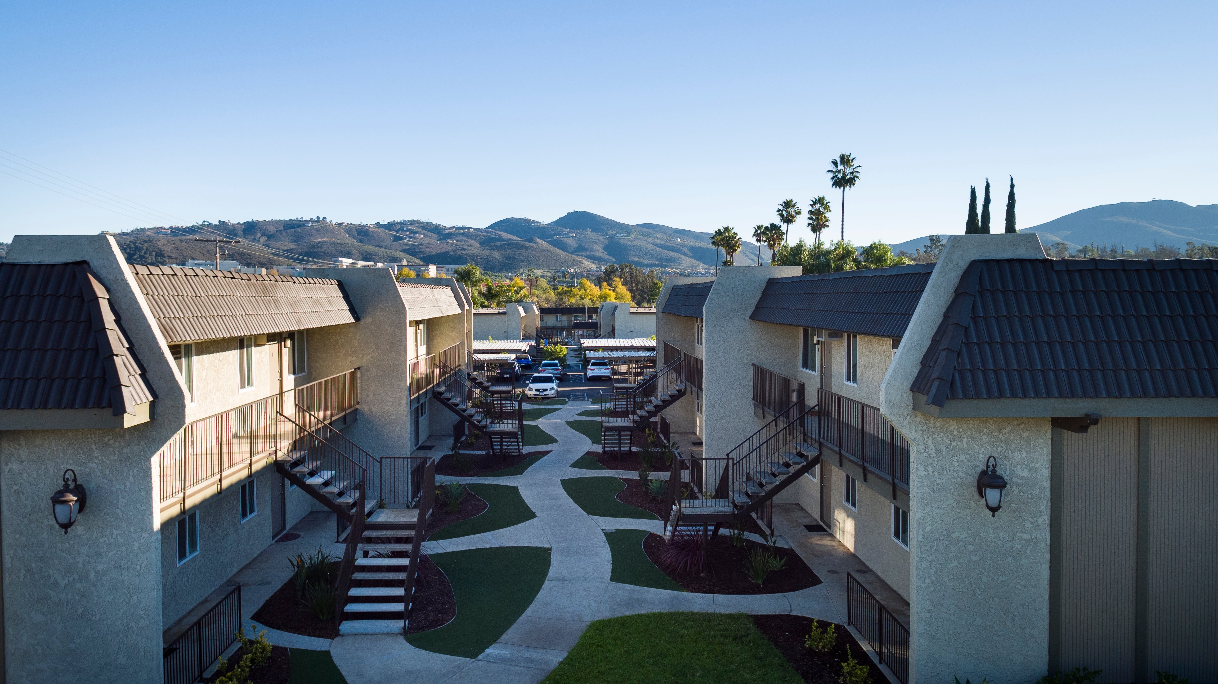 Apartment buildings, exterior stairs, and central walkway at Meadowlark.