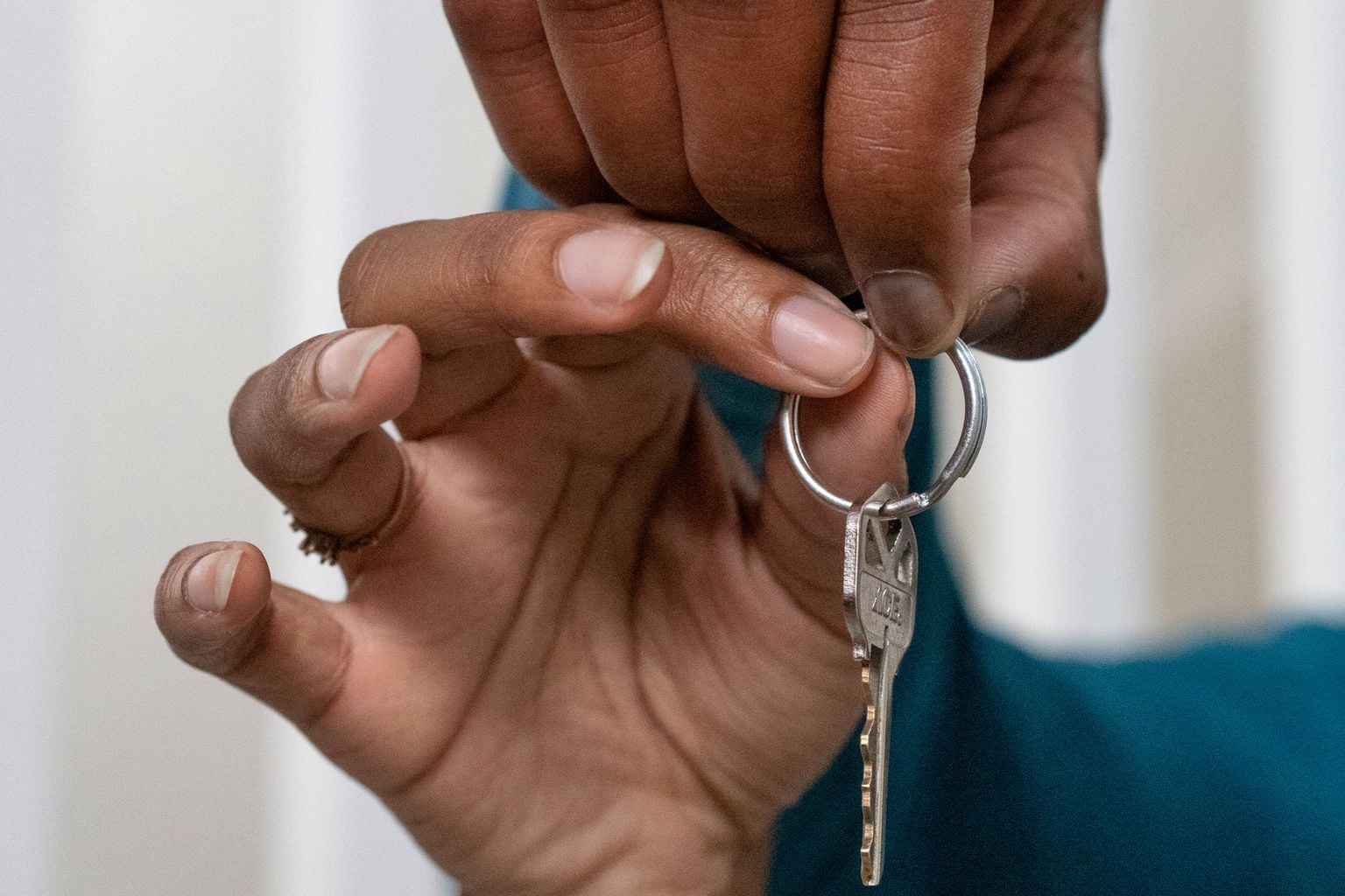 A professional key handoff representing the transition from vacant units to accountable lease-up operations.